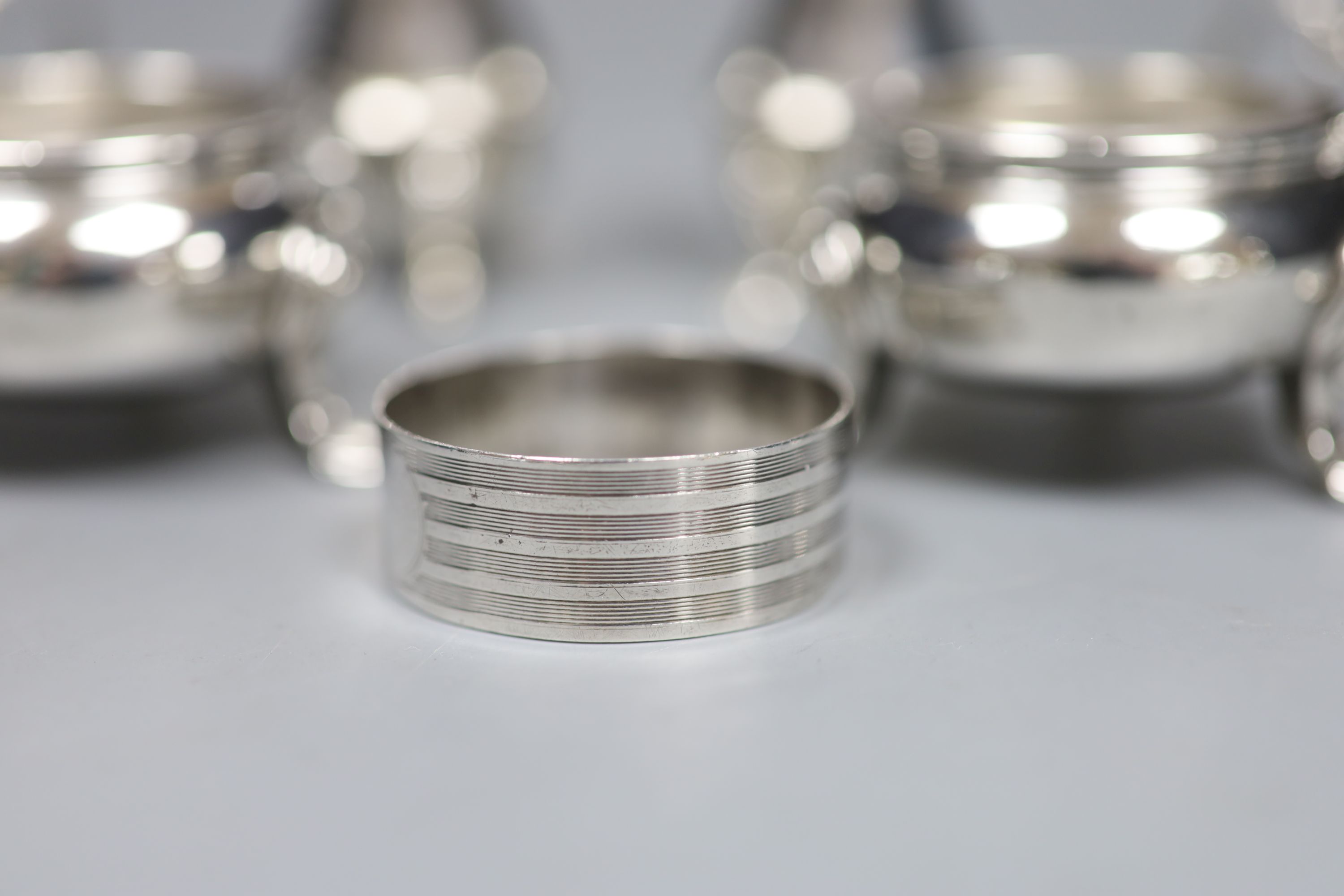 A silver six-piece condiment set, with spoons, Goldsmiths & Silversmiths Co Ltd, London, 1923/4/5 and a silver napkin ring.